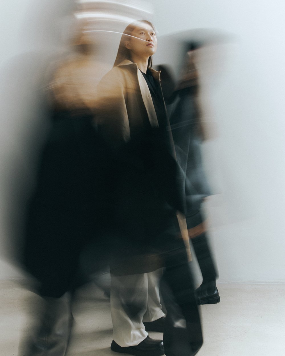 Editorial — long-exposure figure in a camel coat
