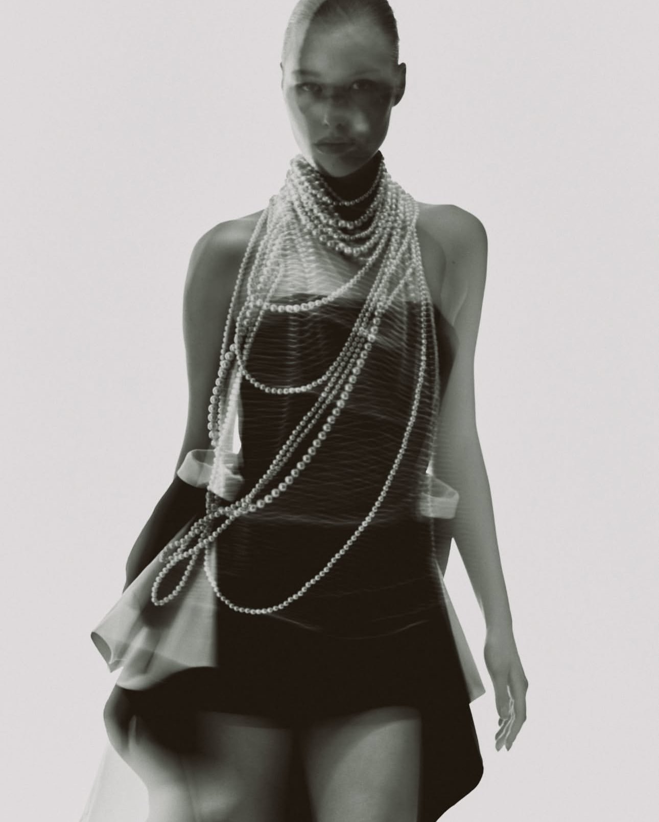 KAMILLA PURSHIE — pearls in motion over a black mini dress