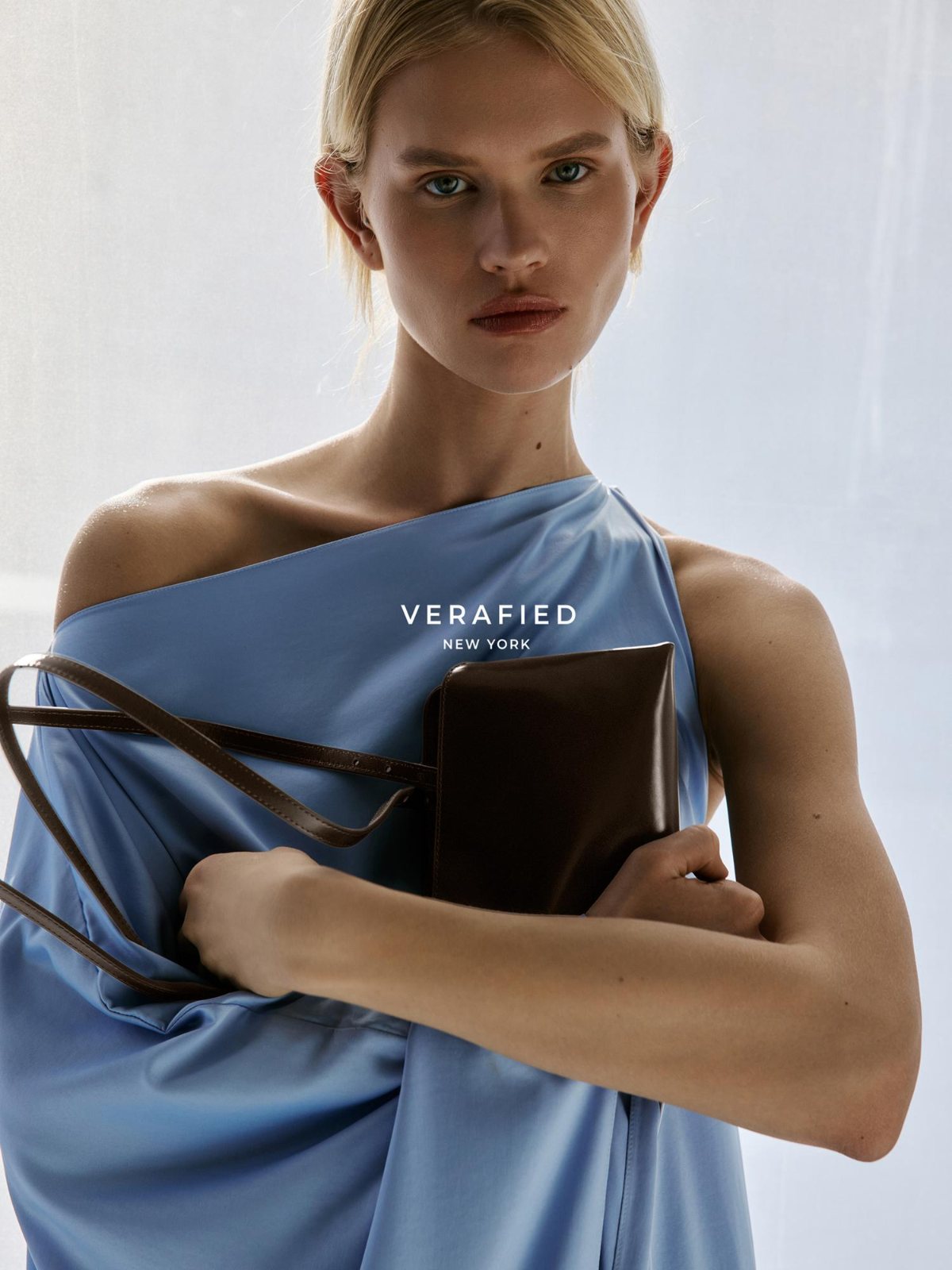 VERAFIED New York — black-and-white portrait from the back, slip dress with a black shoulder bag